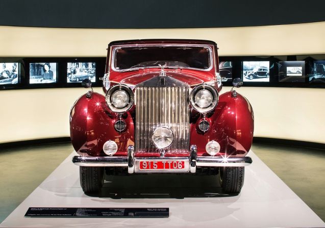 Former tennis player Ion Tiriac, now owner of the biggest chain of car dealerships in Romania, and one of the country’s richest men, puts part of his 250 strong classic car collection on show in Bucharest from 29 November. Probably the most valuable is this 1952 Rolls-Royce Phantom IV, built originally for the Aga Khan on the understanding it wouldn’t ever be sold (just 18 Phantom IVs were built, all for heads of state or royalty). Eventually however it ended up ferry hotel guests to and from the airport in Missouri, USA. Its later years have been much happier. Tiriac bought the car at a Pebble Beach auction in 2011 after which it went on display at the BMW Museum in Munich to mark ten years of Rolls-Royce under BMW ownership (above). Sixty five of Tiriac’s cars will be on show at any one time, rotated every three months, at a showroom in Otopeni, just north of Bucharest. Other famous marques include Bentley, Mercedes, Morgan and Ferrari. The oldest dates from 1899. More details to follow.