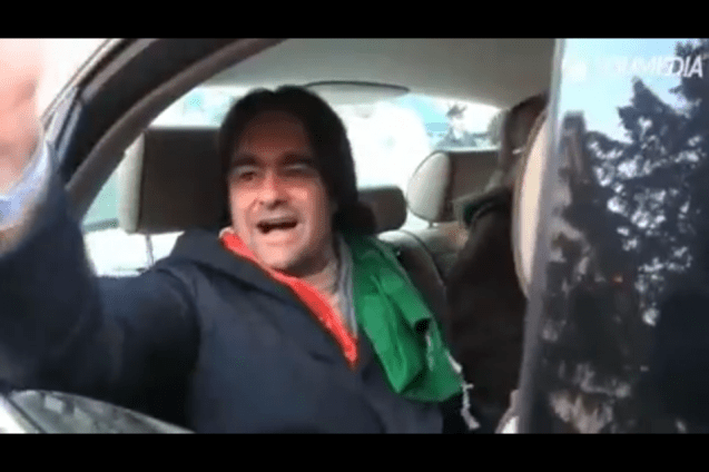 Pitchfork leader Danilo Calvani leaves a stump meeting in Genoa city centre in the back seat of a smart blue jaguar