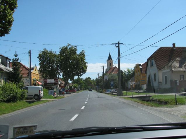 An absolutely typical eastern European village. Trenches each side of the road with concrete bridge driveways to each of the houses. 