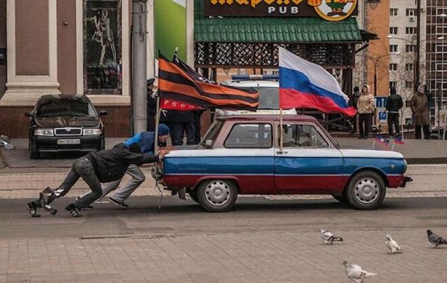 Ukraine: pro-Russia supporters push their ZAZ Zaporozhets through the streets of Donetsk. There was a plan last week to hold a referendum in the south east industrial city, about 50 miles from the Russian border, about joining the UK. Donetsk was founded in 1869 by John Hughes, a Welsh businessman. Photo by Андрей Шокотко, Andrew Shokotko.