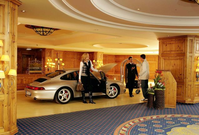 The ultimate road trip luxury: a wood-panelled parking garage and drive in check in, at the Inter Alpen Hotel in